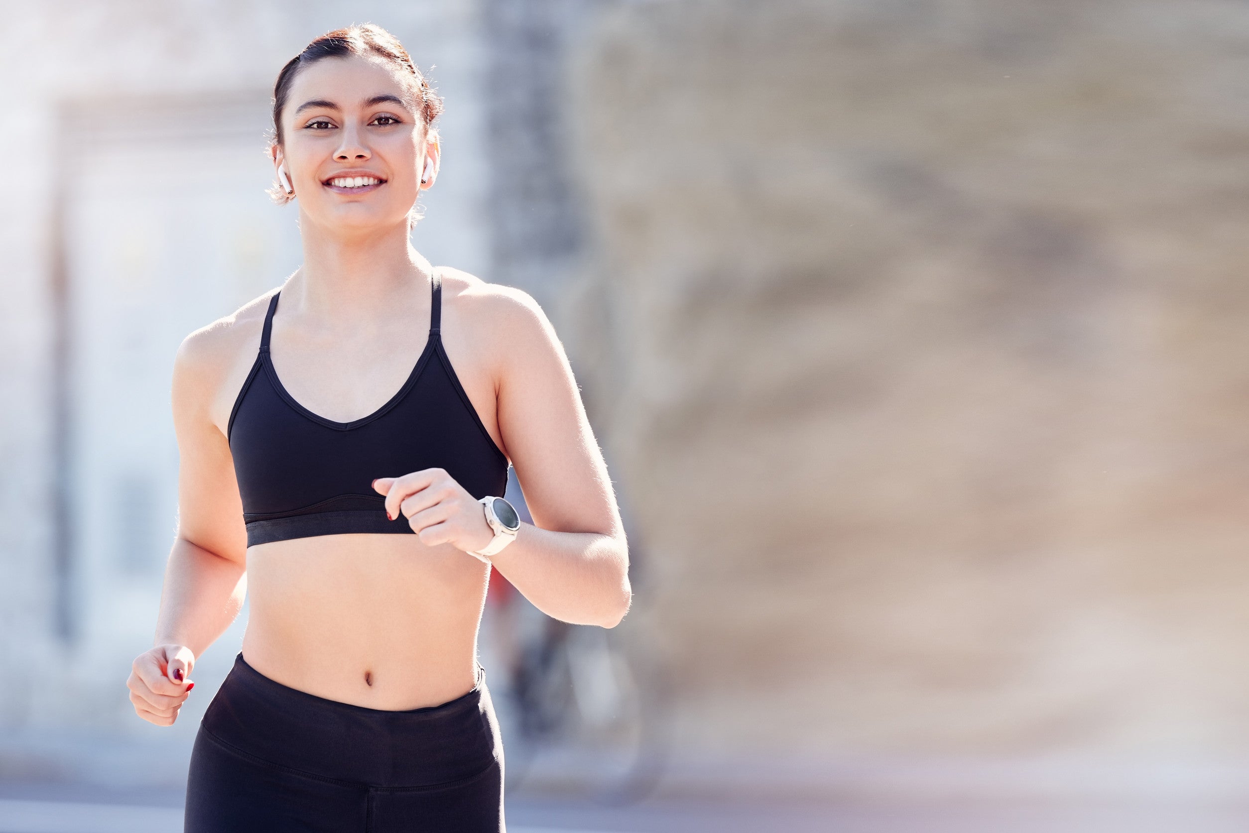 woman running wearing a fitness watch